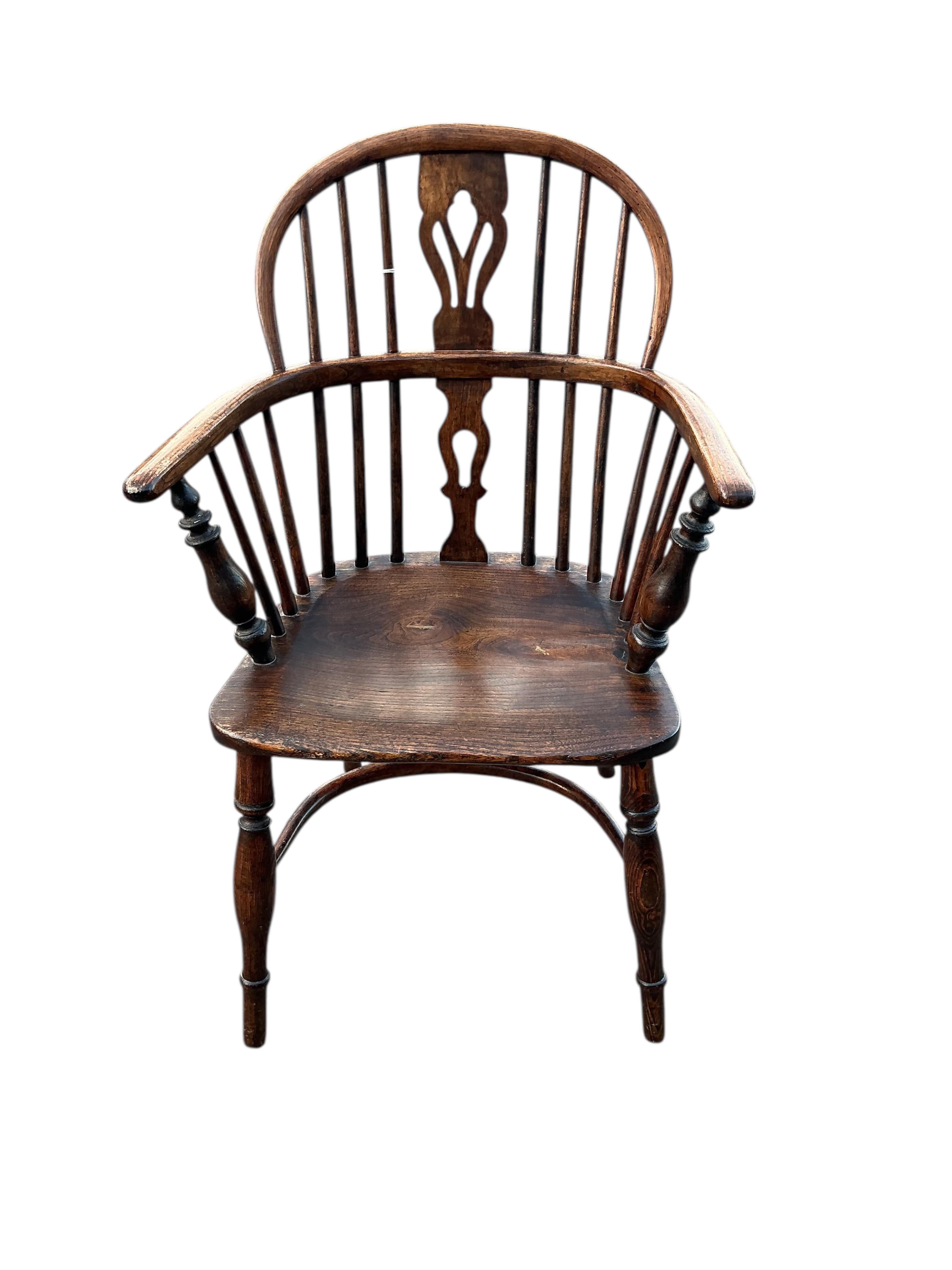 A 19th century Windsor ash and elm elbow chair with crinoline stretcher, width 57cm, depth 38cm, height 91cm